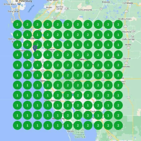 Grid of green circles with numbers arranged over a map area, indicating locations or data points.